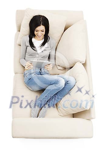 Woman on the couch, reading e-book Woman on the couch, reading e-book