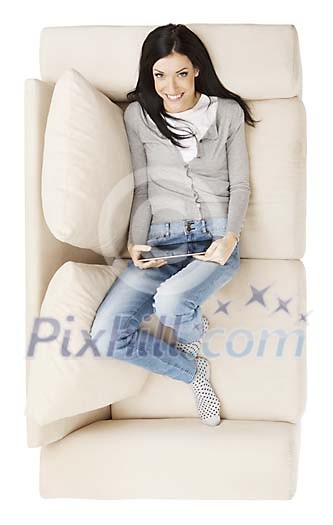 Isolated woman on the couch with tablet Isolated woman on the couch with tablet
