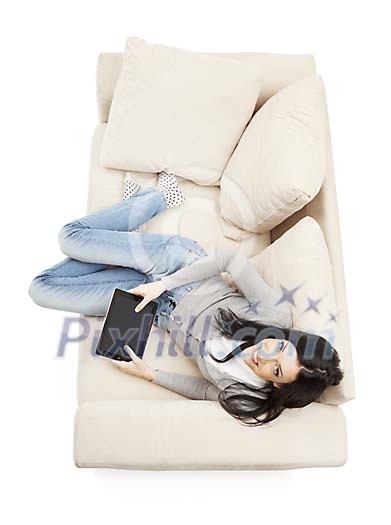 Isolated woman on the couch wit tablet Isolated woman on the couch wit tablet