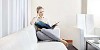 Woman sitting on the sofa, reading a book