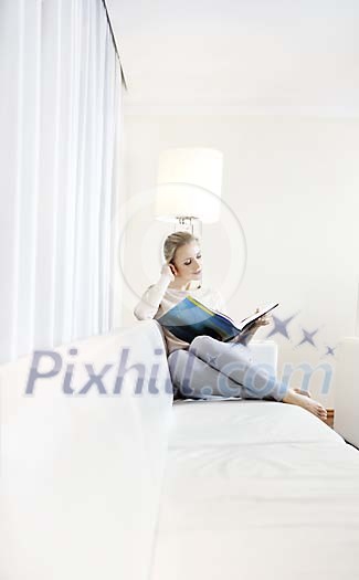 Woman reading a book on the sofa Woman reading a book on the sofa