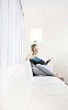 Woman reading a book on the sofa