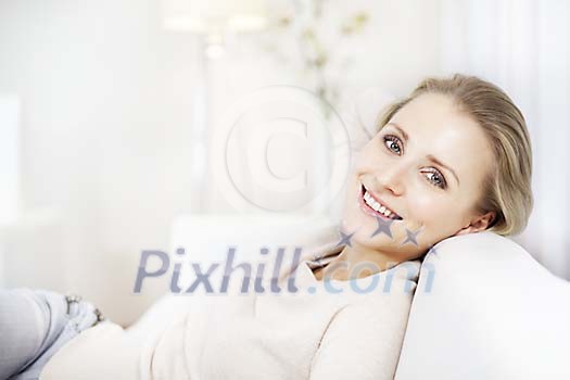Pretty woman smiling on the sofa Pretty woman smiling on the sofa