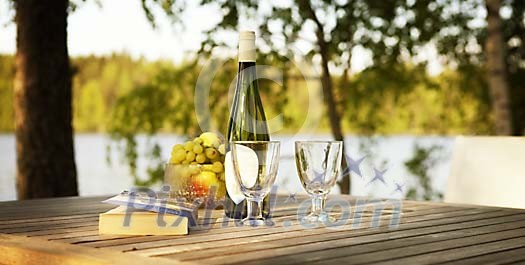 Wine and fruits on the outside table Wine and fruits on the outside table