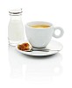 Isolated coffee cup with a bottle of cream