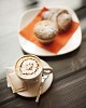 Cappucino and pastry on the wooden table