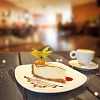Slice of cake and cup of coffee on the table