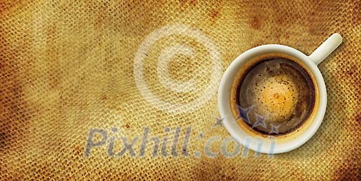 Cup of coffee on a brown fabric Cup of coffee on a brown fabric