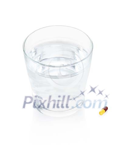 Isolated glass of water with a pill Isolated glass of water with a pill