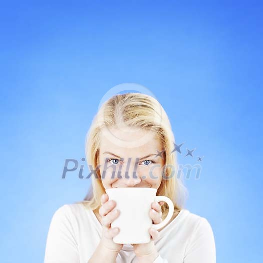 Woman on a blue background drinking coffee Woman on a blue background drinking coffee