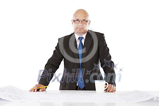 Man looking at camera by a big blueprint