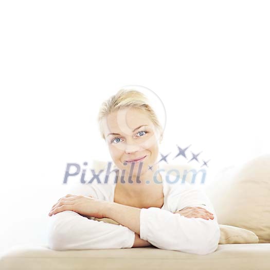 Woman on the couch smiling to the camera Woman on the couch smiling to the camera