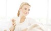 Woman sitting and enjoying a cup of tea in a light surrounding