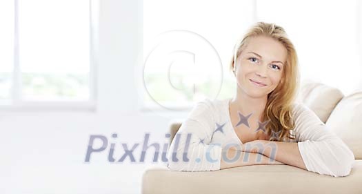 Woman on the couch smiling to the camera Woman on the couch smiling to the camera
