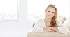 Woman on the couch smiling to the camera