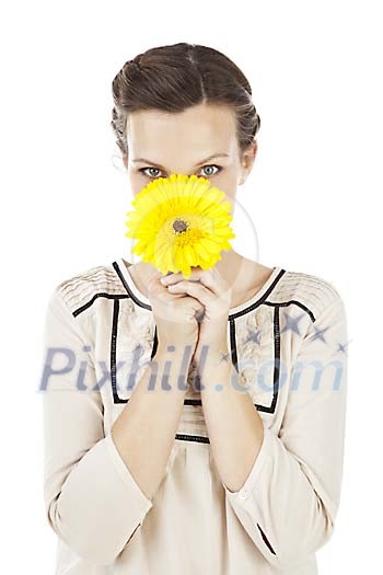 Isolated woman trying to hide behind a flower Isolated woman trying to hide behind a flower