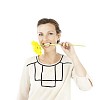 Isolated woman biting a yellow gerbera