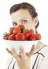 Woman holding a bowl of strawberries