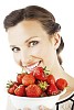 Woman holding a bowl of strawberries and smiling