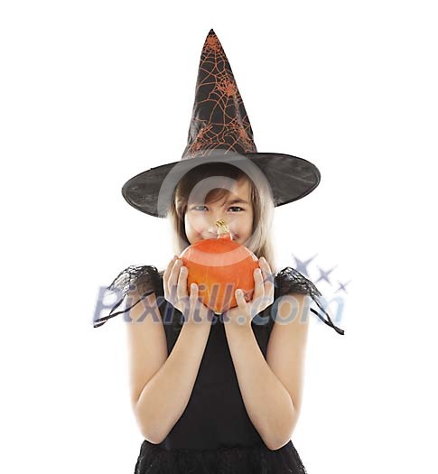 Girl dressed as a witch holding a pumpkin Girl dressed as a witch holding a pumpkin