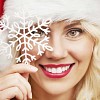 Christmas woman holding a snowflake in front of her face