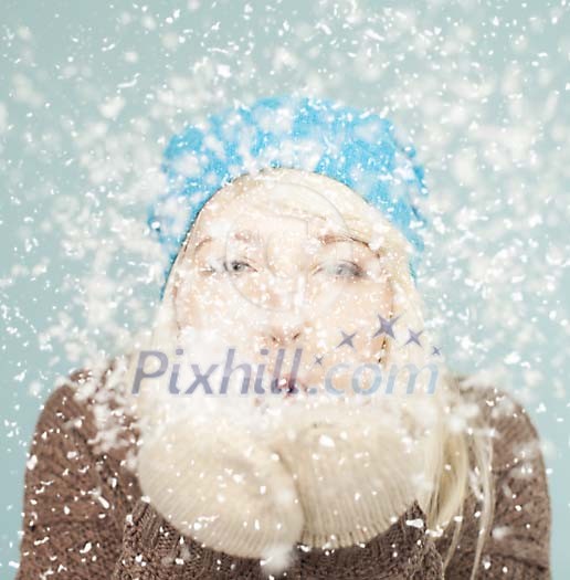 Woman blowing snow in the air Woman blowing snow in the air