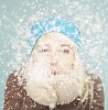 Woman blowing snow in the air