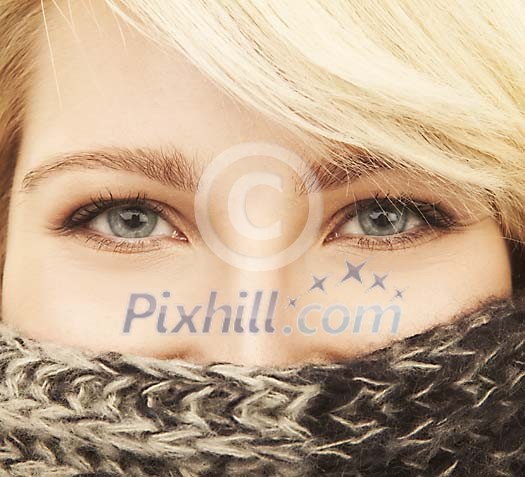Half womans face covered with a scarf Half womans face covered with a scarf