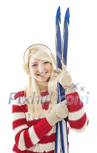 Woman standing with skis Woman standing with skis