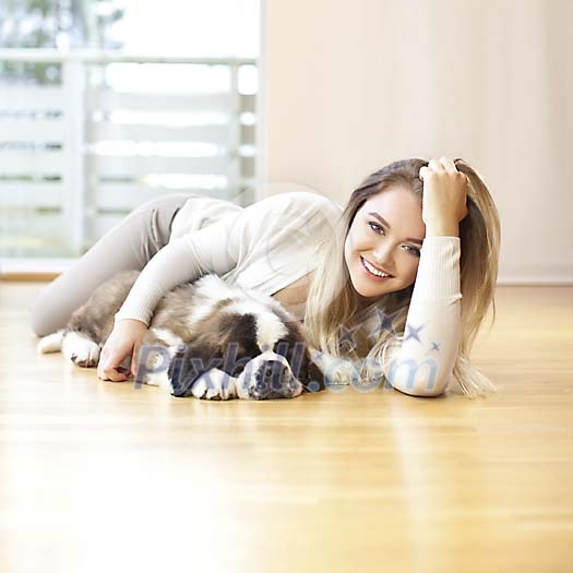 Woman with a puppy on the floor Woman with a puppy on the floor