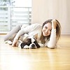 Woman with a puppy on the floor