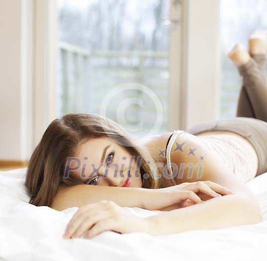 Woman resting on the bed Woman resting on the bed
