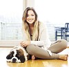 Woman sitting on the floor with a sleeping puppy