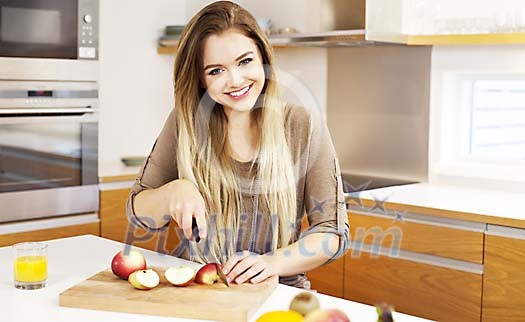 Woman cutting apples in the kitchen Woman cutting apples in the kitchen