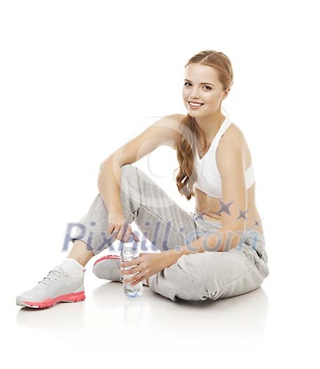 Isolated female sitting on the floor, holding a water bottle Isolated female sitting on the floor, holding a water bottle