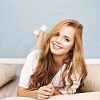 Smiling woman on the floor with pillows