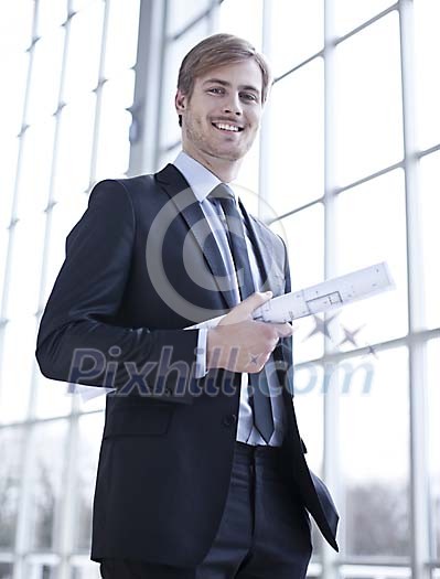 Businessman standing with a blueprint Businessman standing with a blueprint