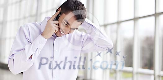 Man smiling and talking to a phone Man smiling and talking to a phone