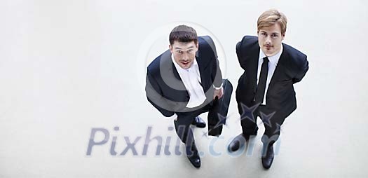 Two businessmen looking up Two businessmen looking up