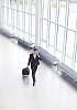 Business walking with a suitcase in a hall