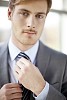 Businessman fixing his necktie