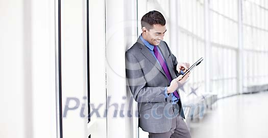 Businessman looking at his tablet computer Businessman looking at his tablet computer