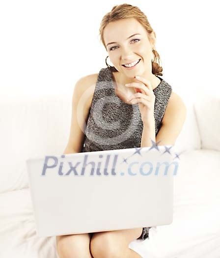 Smiling woman sitting with laptop Smiling woman sitting with laptop