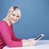 Woman by the table with a tablet computer