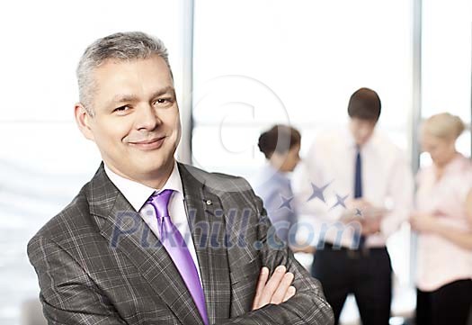 Happy looking businessman with his staff Happy looking businessman with his staff