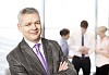 Happy looking businessman with his staff