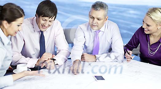 Business people looking at the blueprint Business people looking at the blueprint