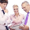 Businessman showing his tablet computer to his co-workers