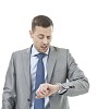 Isolated businessman looking unhappy checking the time