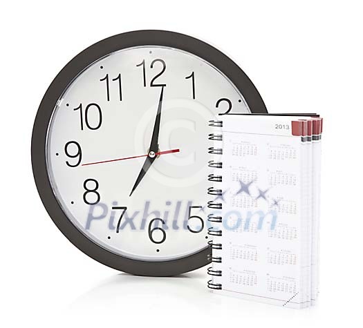Isolated wall clock and agenda Isolated wall clock and agenda